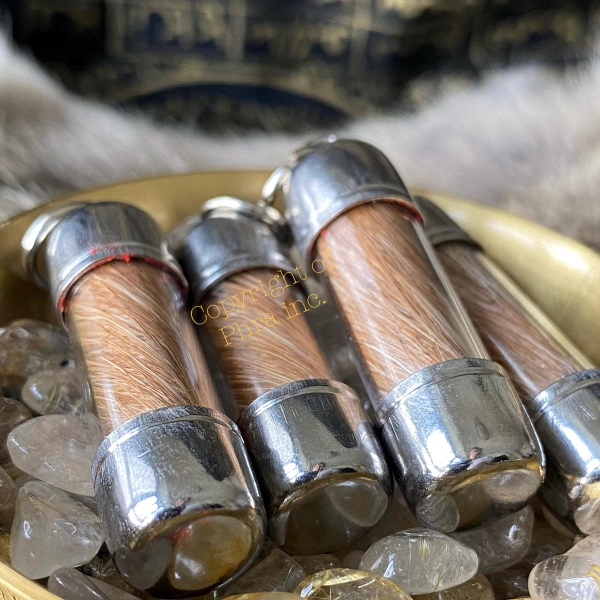 Moroccan hyena scroll amulet held in hand for scale