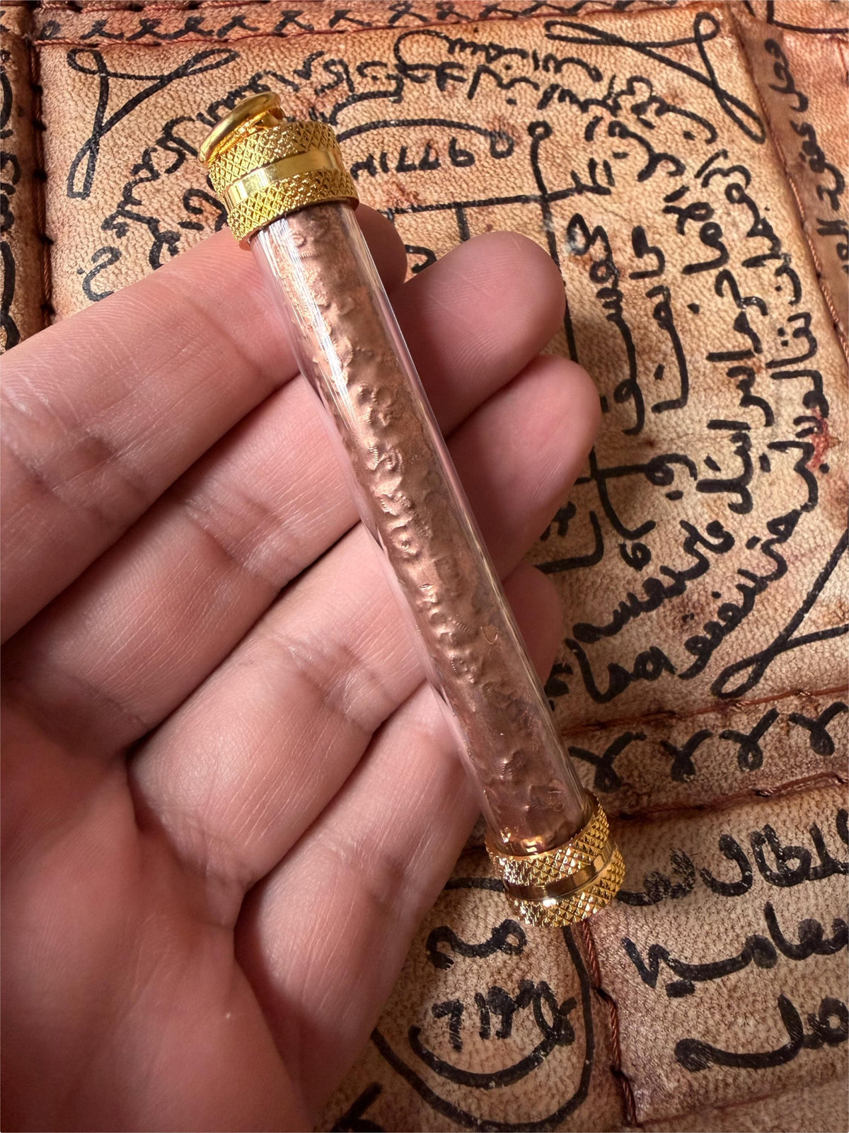 7 Divine Asura takrut amulet held in hand for scale