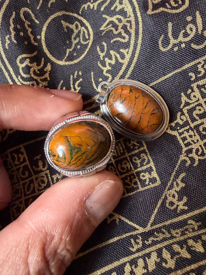 Tiger mustika stone ring shown in hand