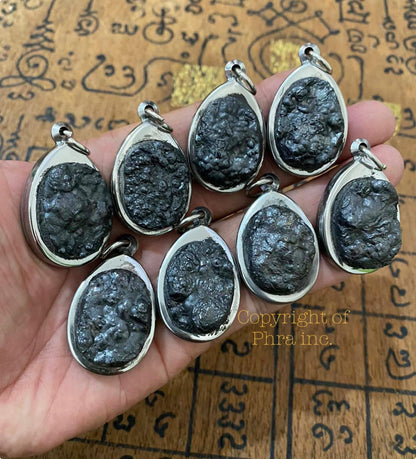 Leklai Tarad pendant held in hand for scale