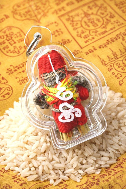 Hoon Payon straw effigy amulet bound with red thread