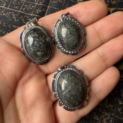 Batu Petir pendant held in hand for size reference