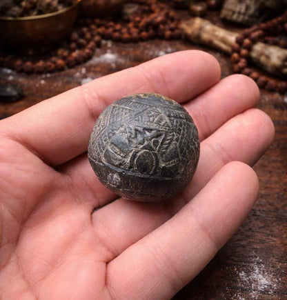 Close up of the coconut shell carving on the Rahu talisman