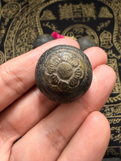 One eye coconut talisman shown beside certificate