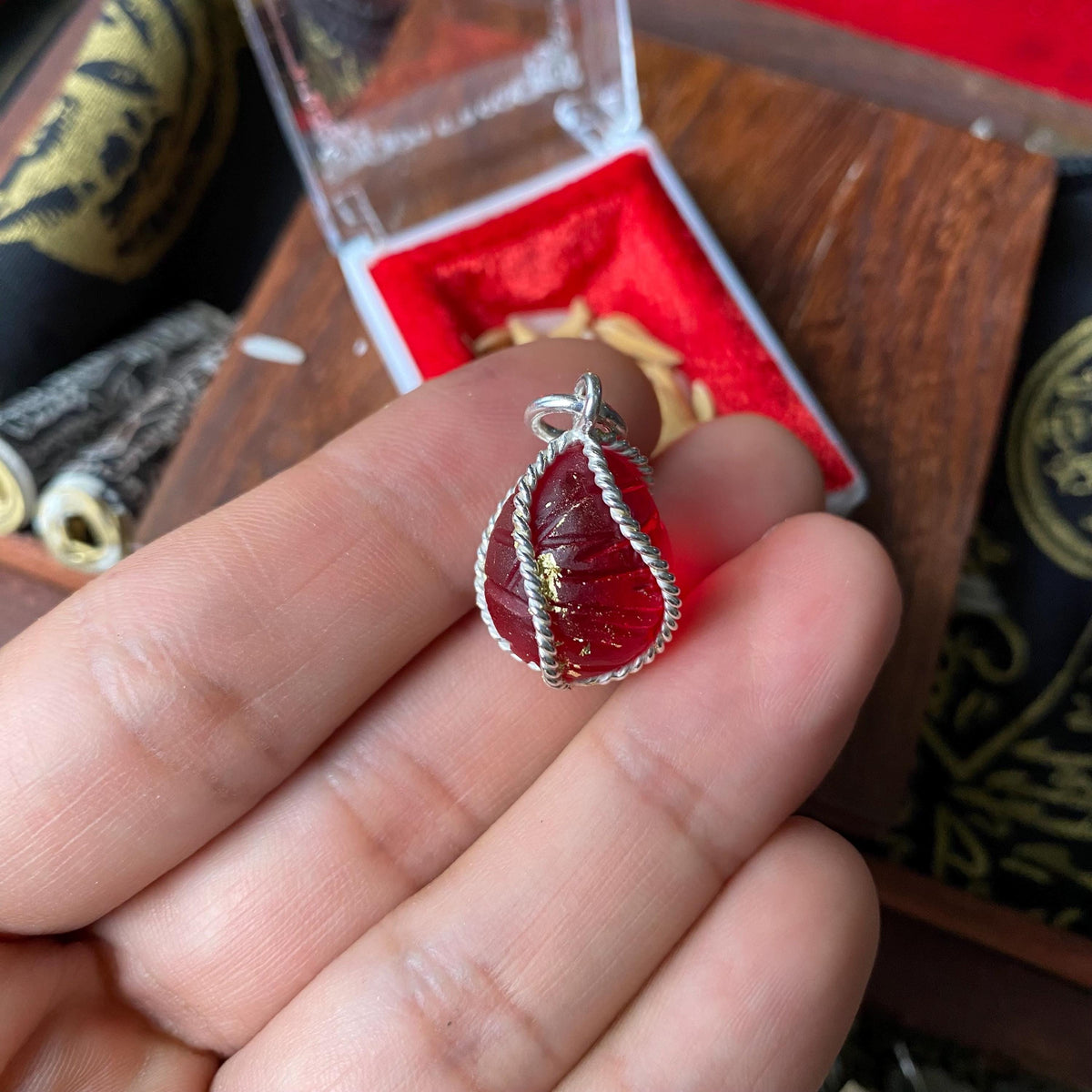 Centipede mustika pearl pendant shown for scale