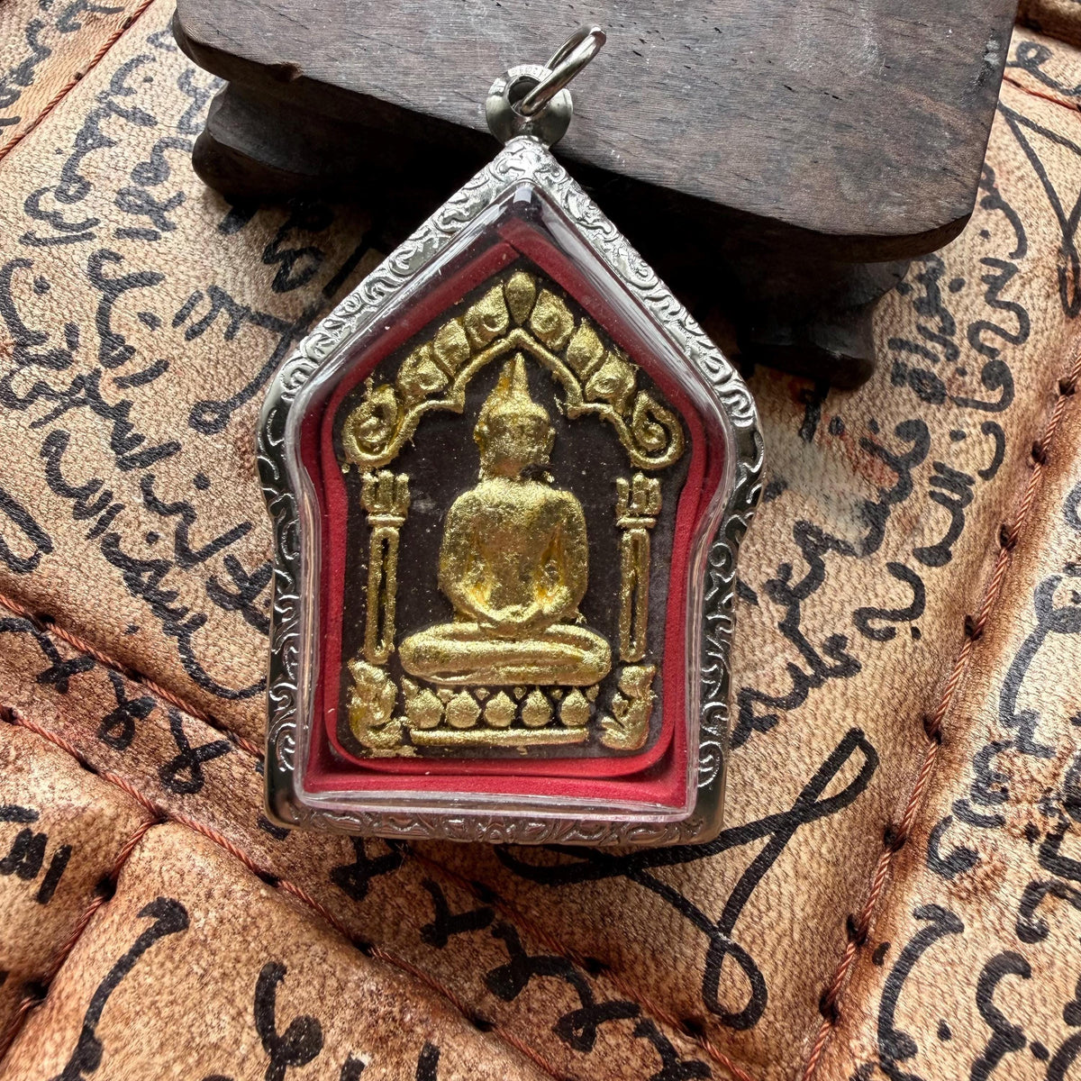 Khun Paen good luck amulet shown at an angle