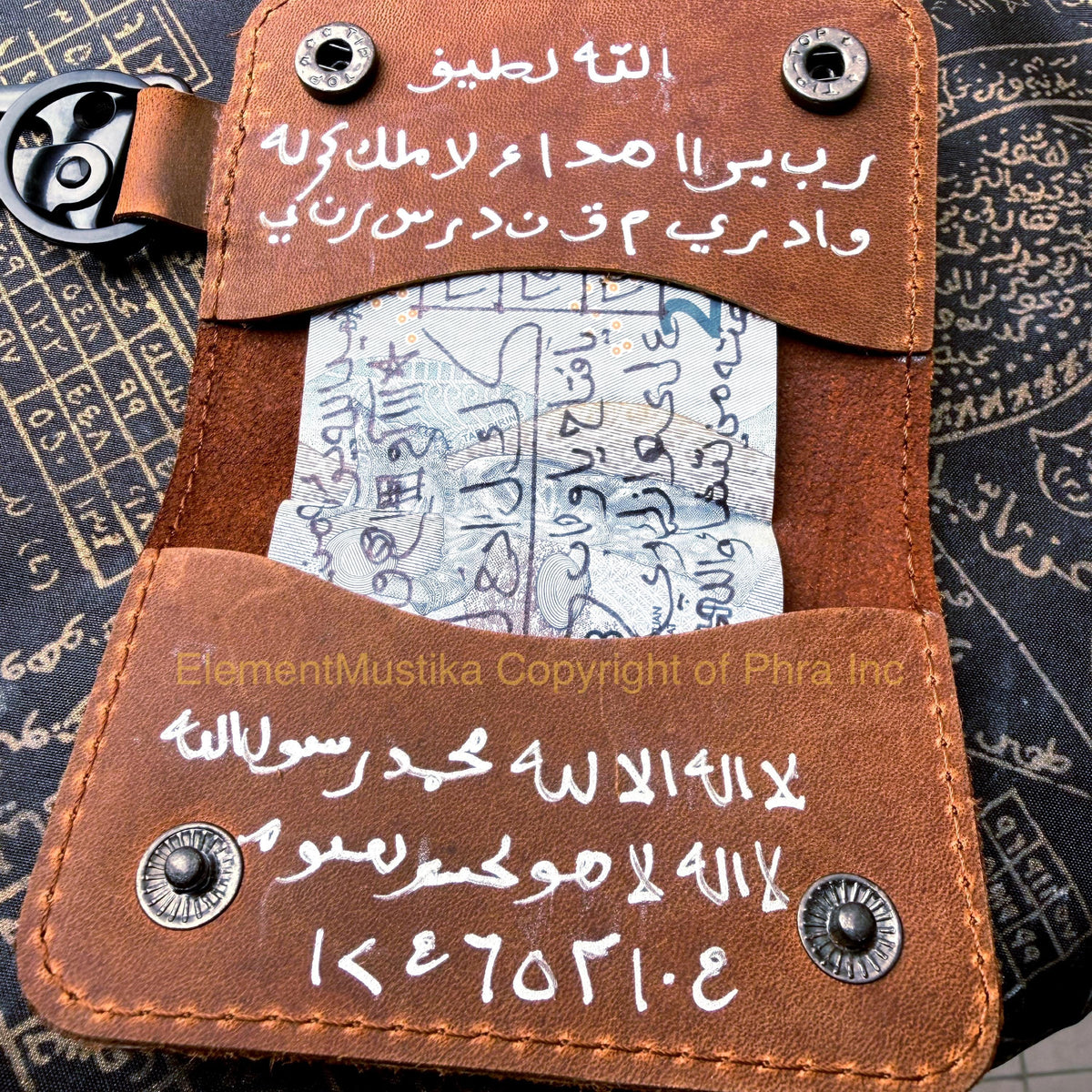 Leather taweez wallet shown in hand for size