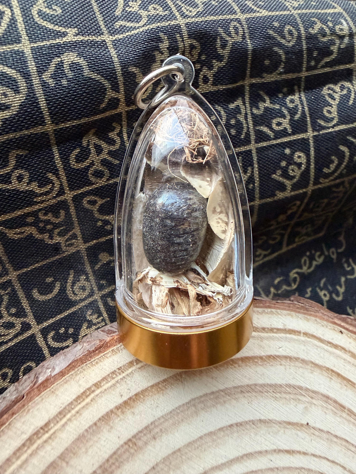 Nagamani serpent pearl amulet held in hand for size