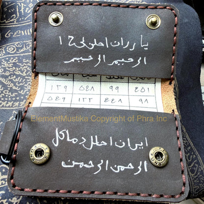Hand inscribed sacred writing inside the leather pouch, close up