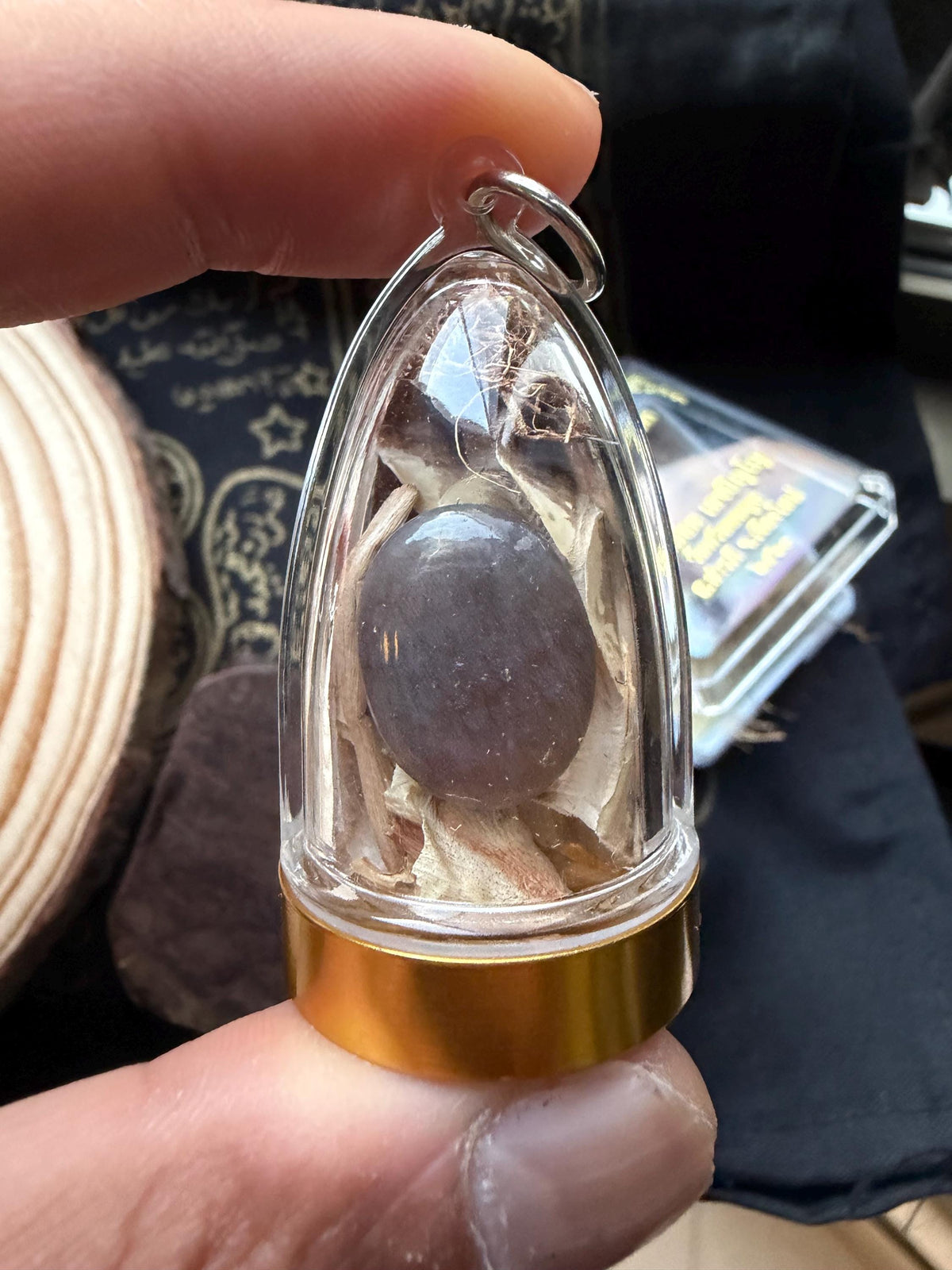 Close-up of the black cobra bezoar pearl inside the acrylic housing