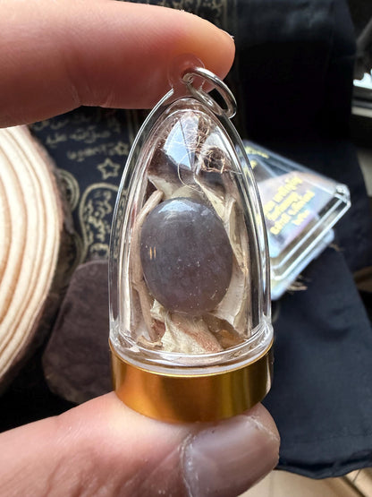Close-up of the black cobra bezoar pearl inside the acrylic housing