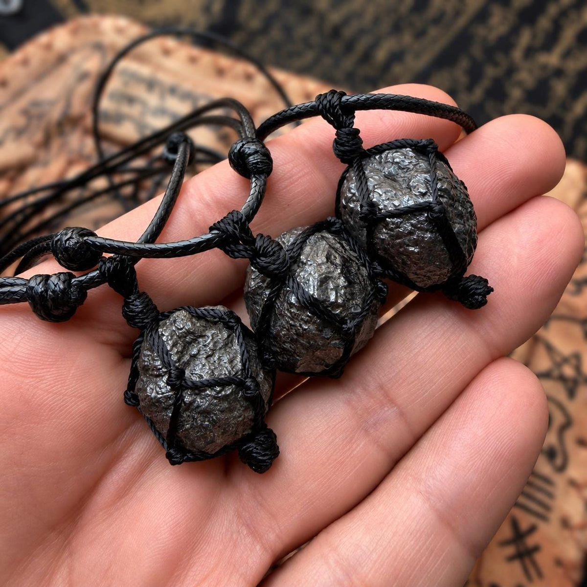 Munta Besi bangle and pendant versions shown together