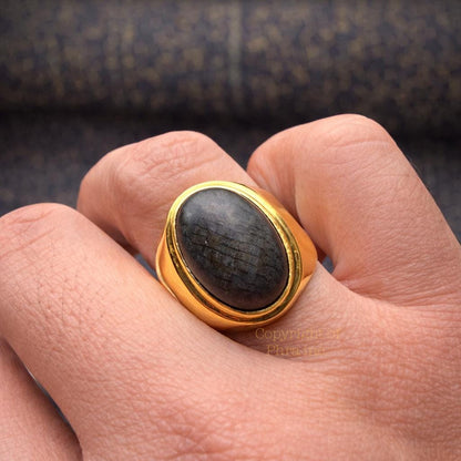 Black Nagamani cobra stone ring in gold plated silver, front view