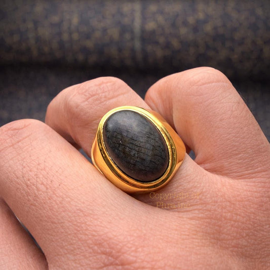 Black Nagamani cobra stone ring in gold plated silver, front view